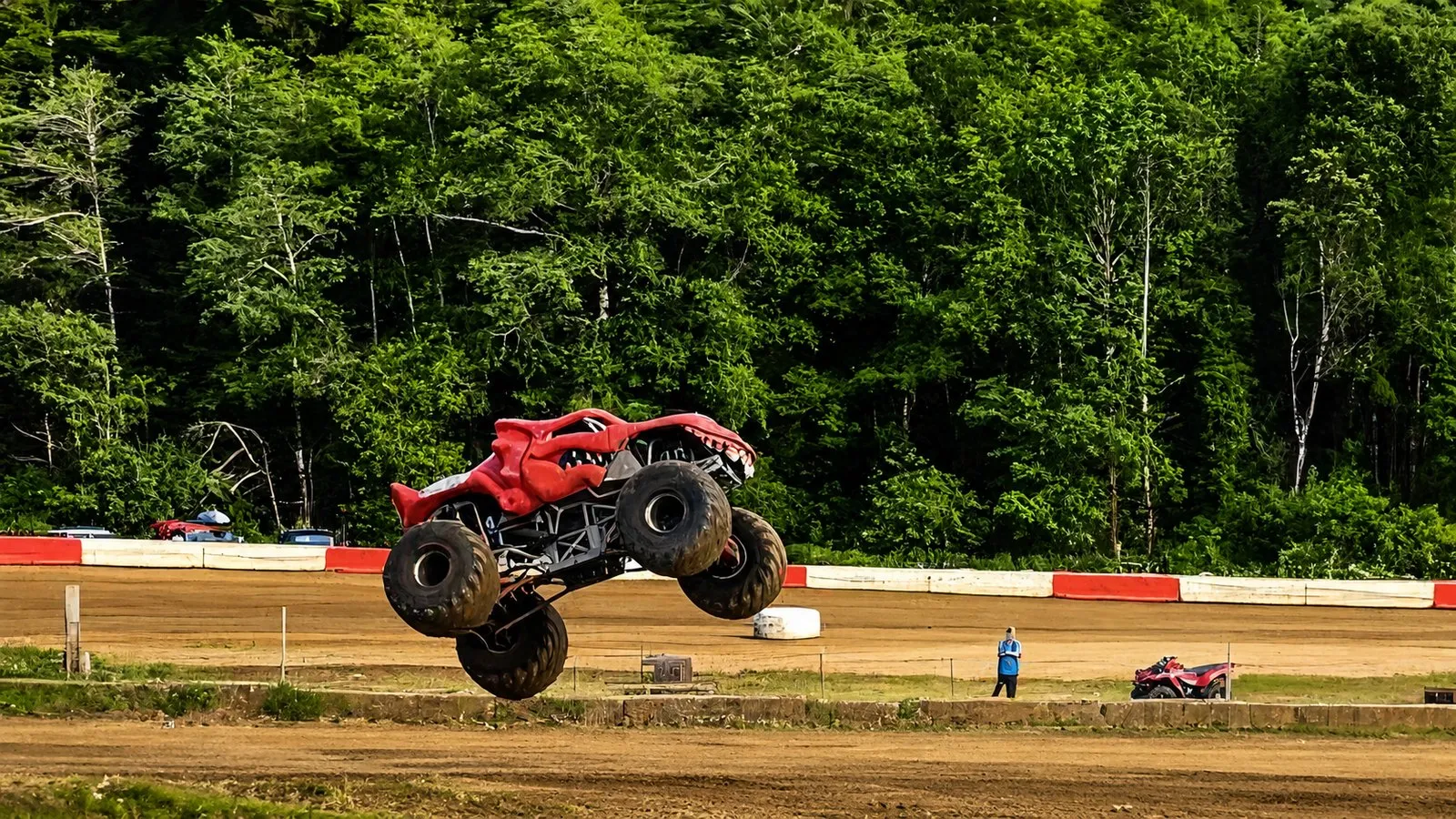 A monster truck flying high over the dirt oval at Coos Bay Speedway