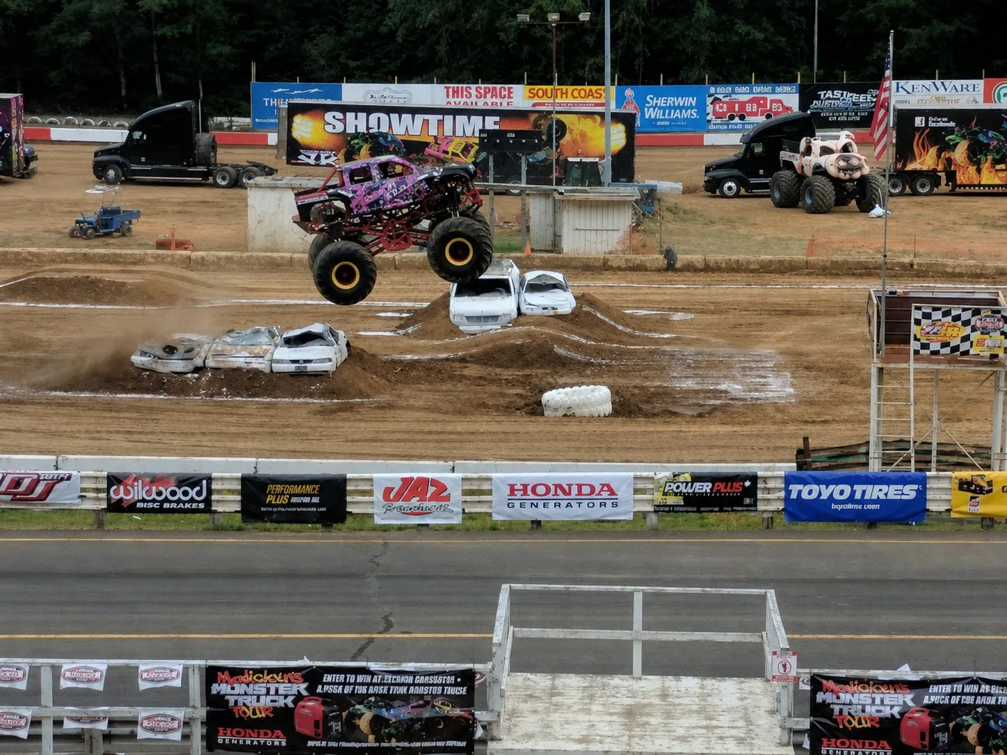 Monster truck jumping over crushed cars at a Coos Bay Speedway show